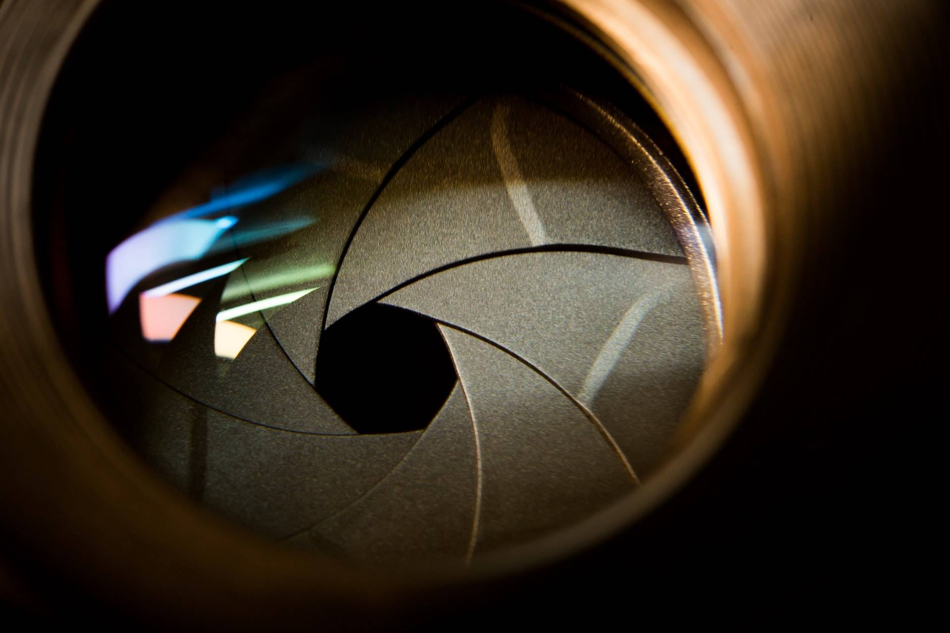 Photo of a camera lens where you can see the opening of the lens in the middle that allows light to pass through